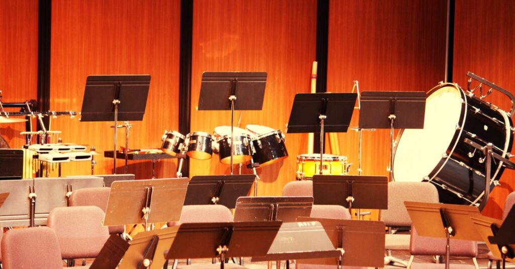 Orchestra stage with music stands and drums